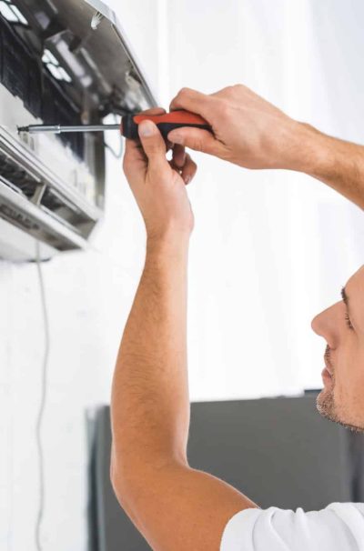 handsome-adult-man-repairing-air-conditioner-with-screwdriver.jpg